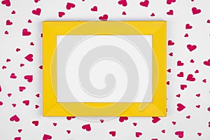 Yellow frame on red hearts background with copy space