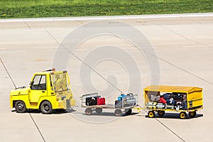 Yellow freight trolleys with loaded baggage