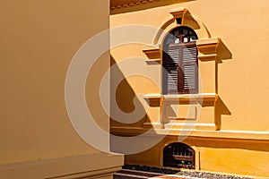 Yellow French Colonial building facade and window frame of Udon Thani city museum, Thailand
