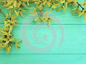 yellow fresh autumn flowers on mint wooden texture background