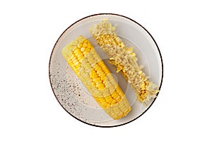 Yellow fresh boiled sweet corn cob and core on vintage plate isolated on white background