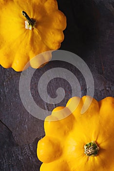 Yellow fresh squash patty pan on the dark stone background vertical