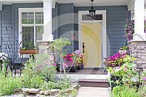 Yellow front door of a small house in the suburbs of Canada