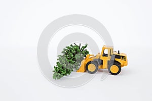 Yellow front loader truck with green tree isolate on white background