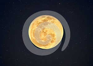 Yellow full moon with crater textured glowing with starry in night sky