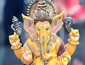Yellow Ganesh Elephant Hindu god statue closeup focused on face