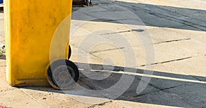 Yellow garbage bin on the street