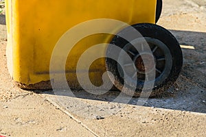Yellow garbage bin on the street