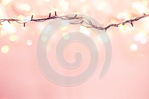 Yellow garland on a pink background. Holiday Christmas concept