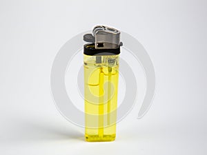 A yellow gas lighter on a white background