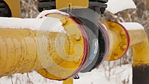 Yellow gas pipe in the snow winter gas heating