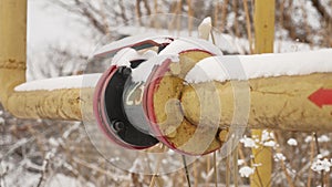 Yellow gas pipe in the snow winter gas heating