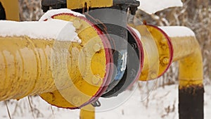 Yellow gas pipe in the snow winter gas heating