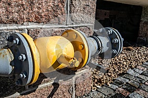 Yellow gas pipe on the wall of the building