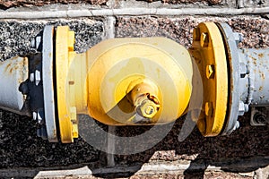 Yellow gas pipe on the wall of the building