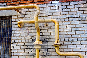 Yellow gas pipes on the wall