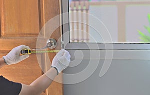 Yellow gauge strip, door knob, door installation technician, clear outside atmosphere