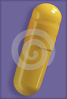 Yellow gel capsule close up.