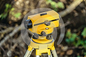 Yellow geodetic optical level on a tripod