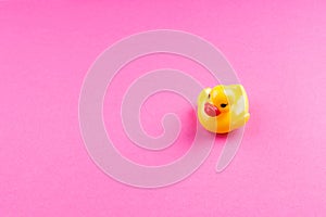 Yellow glamour rubber duck on pink background