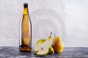 Yellow glass bottle with drink. Bottle and fruit. Citro and pears. Sparkling water and pears