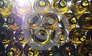 Yellow glass empty beer bottles lie in rows,Glass beer bottles lie in rows, necks on camera, shallow depth of sharp