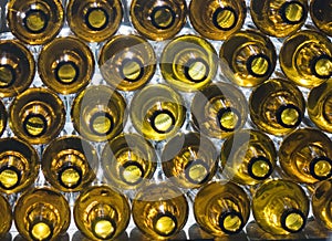 Yellow glass empty beer bottles lie in rows,Glass beer bottles lie in rows, necks on camera, shallow depth of sharp