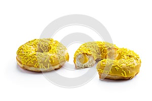 Yellow glazed doughnuts in gray tray isolated on white