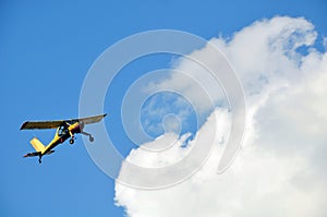 Yellow glider against a blue sky