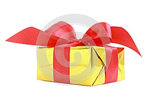 Yellow glossy gift wrapped present with red satin bow