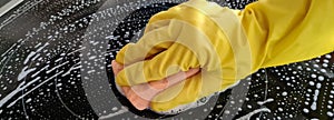 Yellow glove sponge for washing stove and washing stove