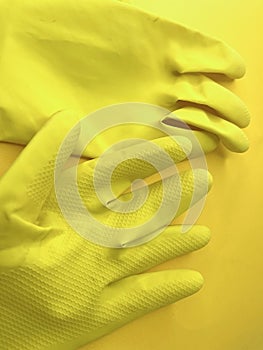 Yellow gloves in a yellow background