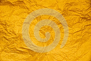 Yellow gold crumpled paper abstract for texture background