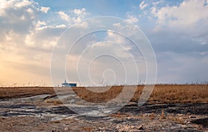 Yellow grass field with isolated church and dramatic sky at morning from different angle