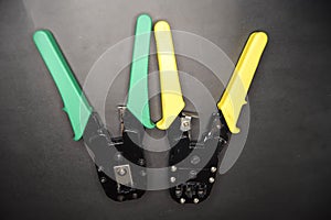 Yellow and green adjustable wire stripper isolated on a black background, Adjustable wire stripper isolated isolated a black
