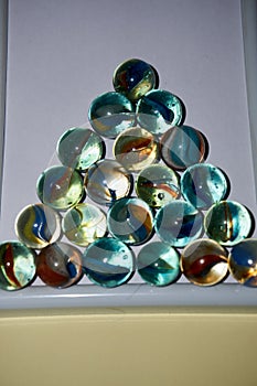 Yellow, green, blue and red glass marbles on a table