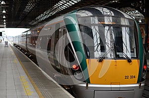 Yellow and Green Irish Train stopped at the Station