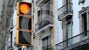 Yellow and green modern traffic light on cityscape background