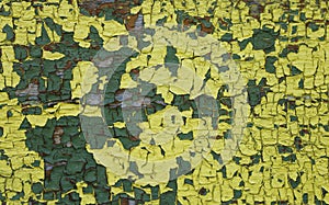 Yellow green  old painted wooden surface with peeling cracked paint