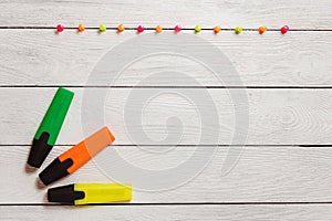 Yellow, Green, Orange Highlighter, Colorful Pushpins on White Wooden Table, Stationary, Copy Space. School Concept.