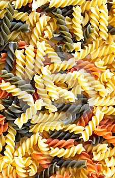 Yellow , green and orange spiral pasta background photo