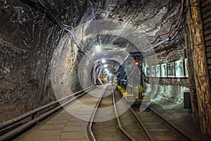 Yellow and green passenger train in a mine