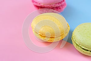 Yellow, green and pink round biscuits close up