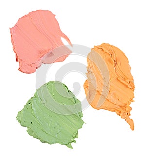 Yellow, green and red concealer swatch isolated over white