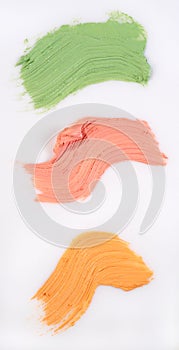 Yellow, green and red concealer swatch isolated over white