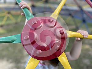 Yellow green and red monkey bars Toddler playing at the park