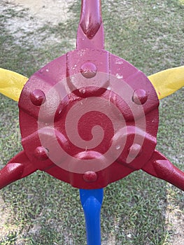 Yellow green and red monkey bars Toddler playing at the park close up