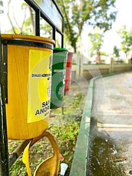 Yellow Green Red Recycle Bins in the Garden