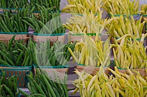 Yellow and Green string Beans in farmers wooden baskets at market