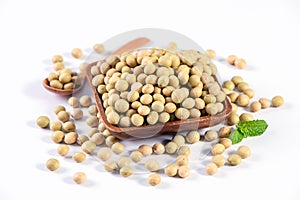 Yellow-green Taiwanese organic non-GMO soybeans, soy beans in a container isolated on white backgorund, close up, clipping path